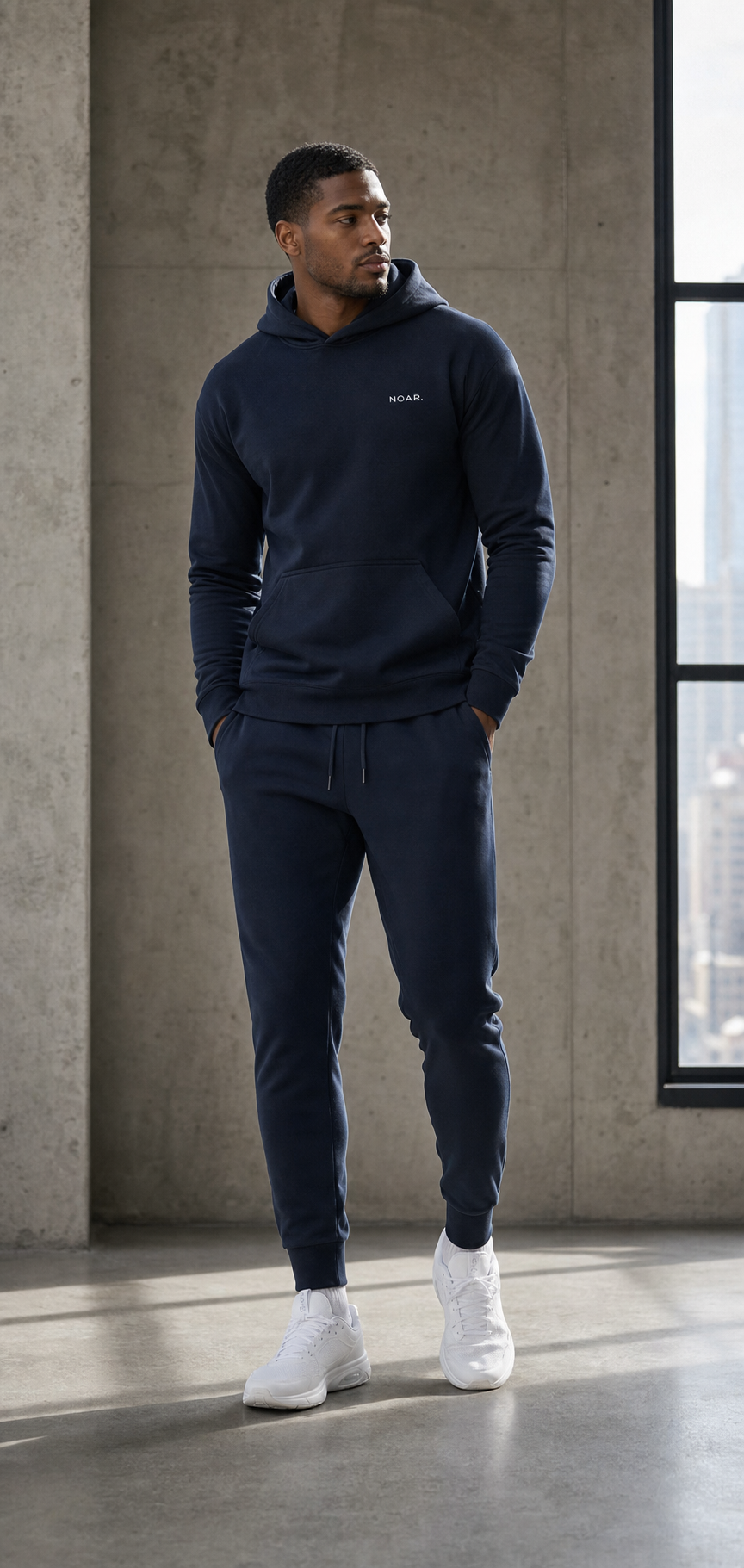 Male model wearing a navy NOAR jogging set